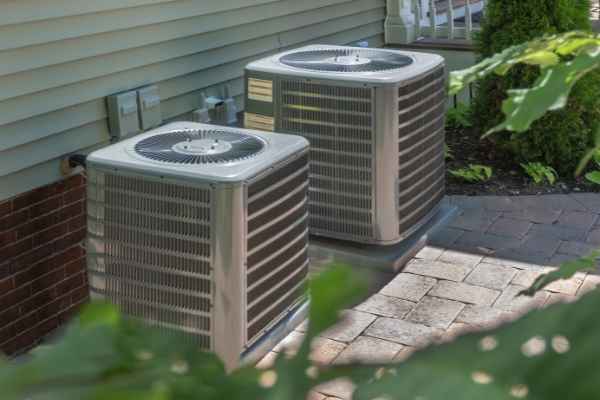 The Woodlands AC Repair fixing a central AC unit at a residential home in The Woodlands, TX